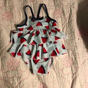 One piece swimsuit. Comes with watermelon designs